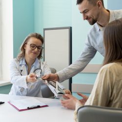 gynecologist-evaluating-pregnancy-with-patient